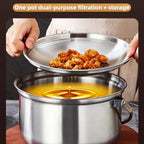 A stainless steel dual-purpose pot with a lid being lifted to show both sides, over a pot of oil. A hand holds the lid while another hand holds the pot handle.