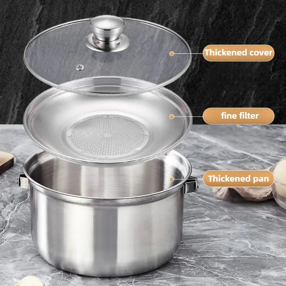 A stainless steel pot with a thickened lid, shown with a glass lid and a fine filter insert labeled with callouts: 'Thickened cover,' 'fine filter,' and 'Thickened pan.' The pot sits on a gray stone surface against a dark gray background.
