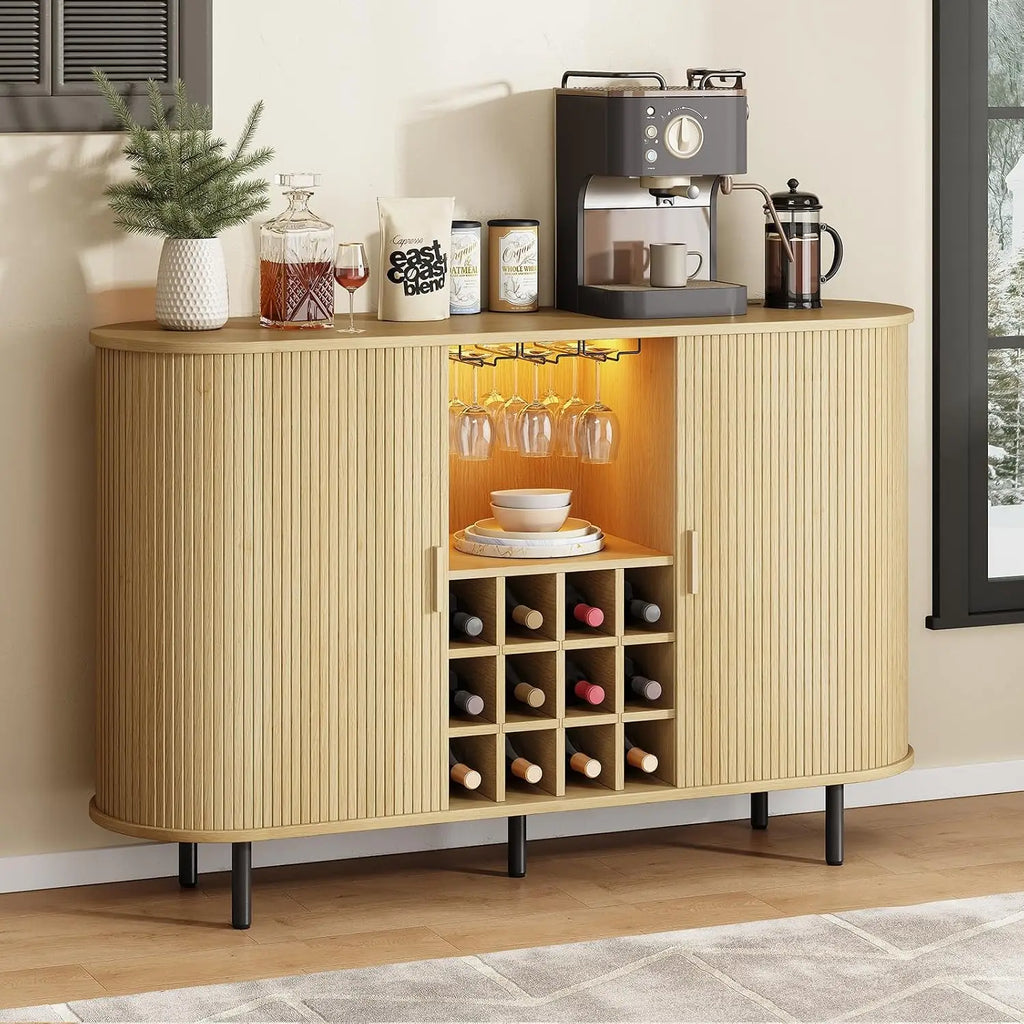 Beige sideboard with coffee machine, wine bottles, and glasses in a home setting.