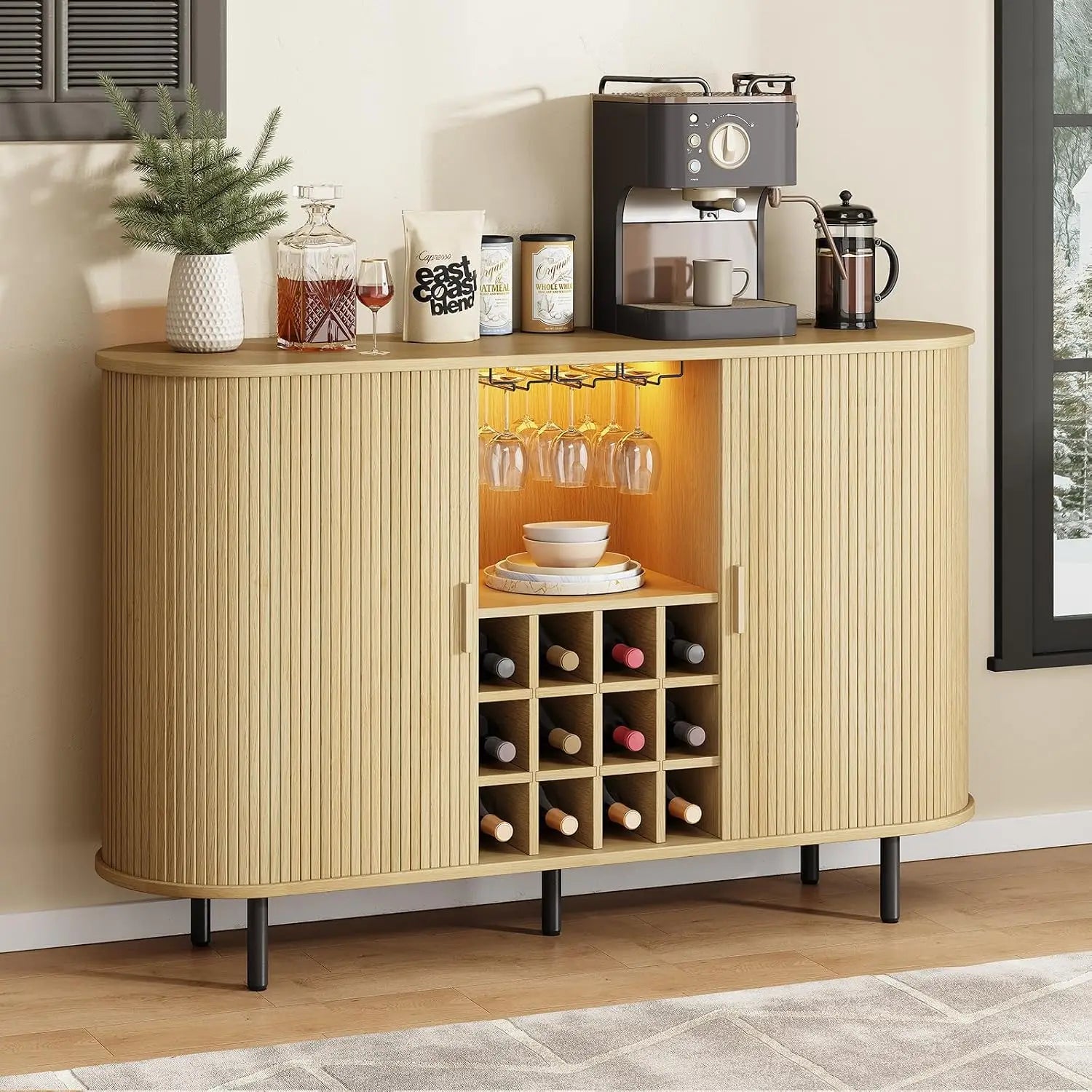 Beige sideboard with coffee machine, wine bottles, and glasses in a home setting.