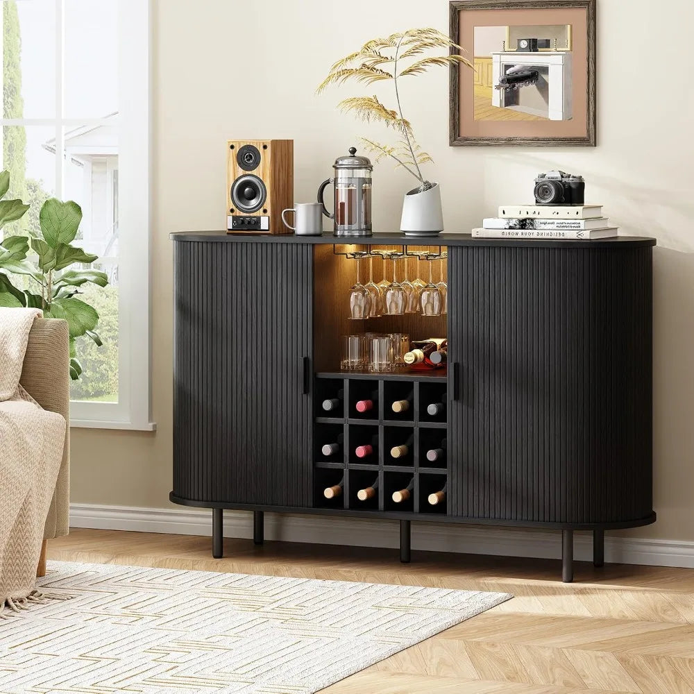 Black bar cabinet with wine bottles, glasses, and decor in a living room setting.