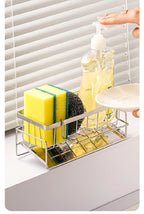 Cleaning supplies including a bottle, sponge, and scrubber in a metal caddy with a window blind background.
