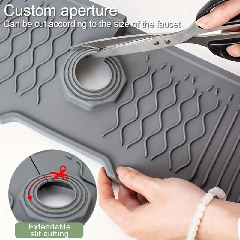 Gray silicone mat with customizable cutout, being cut with scissors, on a white background.