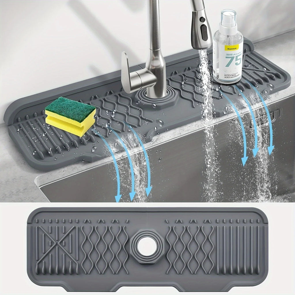 Gray silicone sink mat with water drainage holes in a kitchen setting.