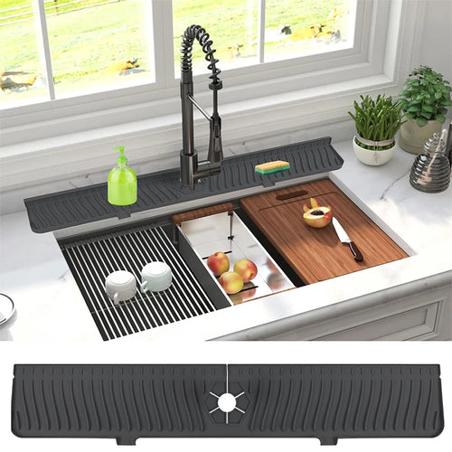 Kitchen sink with a black rubber mat on the counter, apples, and a cutting board.