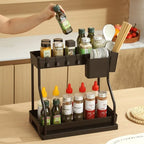 Sinkelle.com Black kitchen organizer with various bottles and utensils on a wooden countertop.