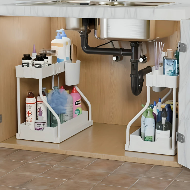 Under-sink cabinet organization with cleaning supplies and storage racks.