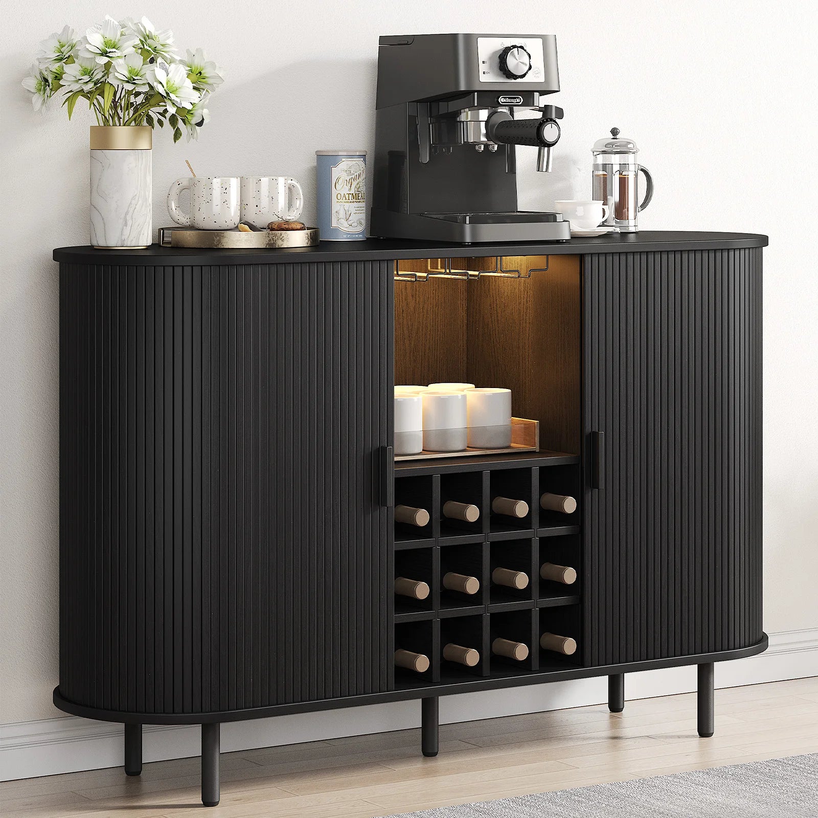 Black bar cabinet with wine storage and coffee-making equipment on a light wood floor.