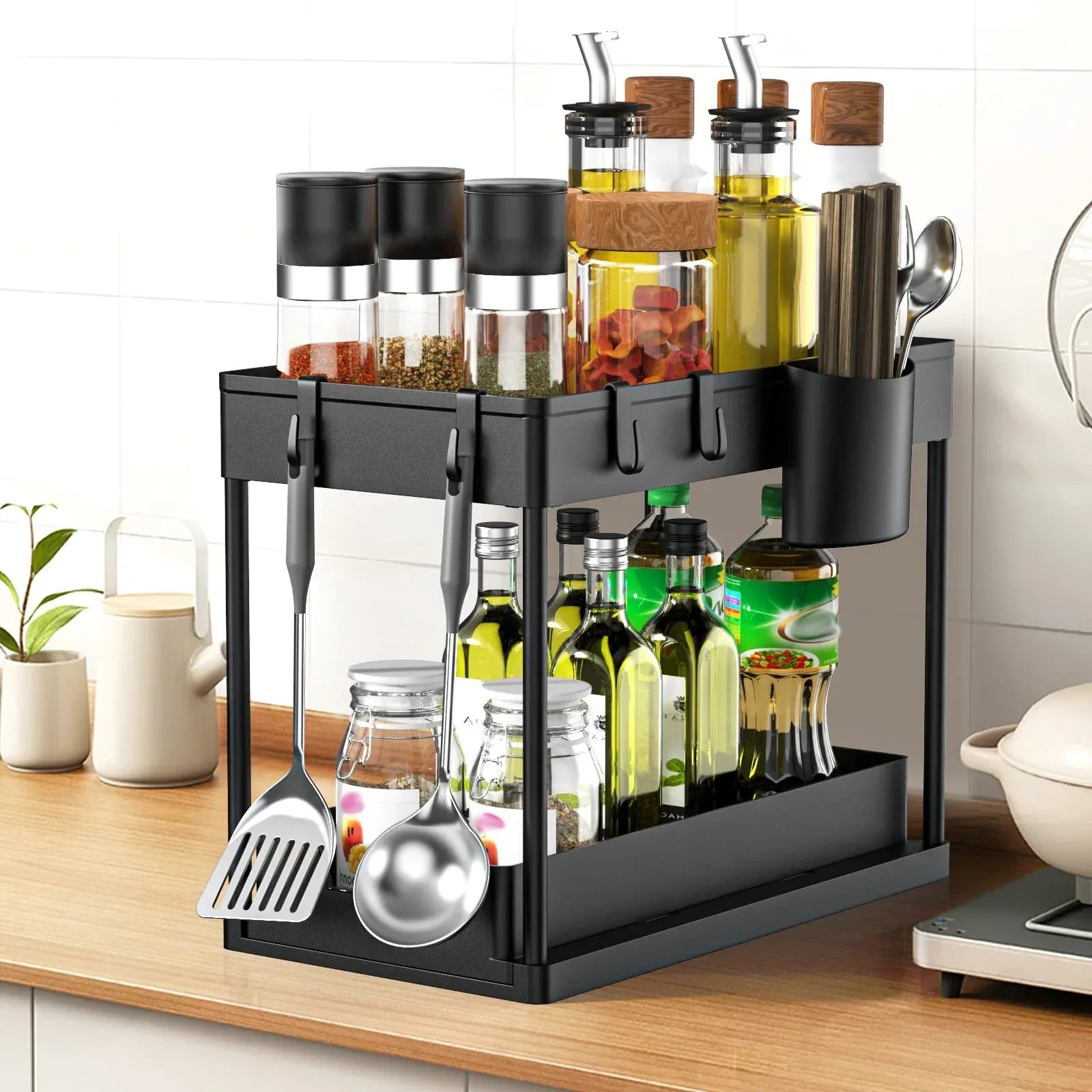 Black kitchen utensil and spice rack on a wooden countertop with various bottles and utensils.