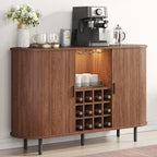Wooden bar cabinet with open door displaying bottles, coffee maker, and other items on a white wall background.