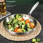 Stainless steel frying pan with vegetables on a woven mat