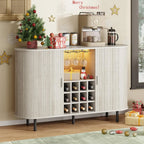 White sideboard with wine bottles, coffee machine, and Christmas decorations.